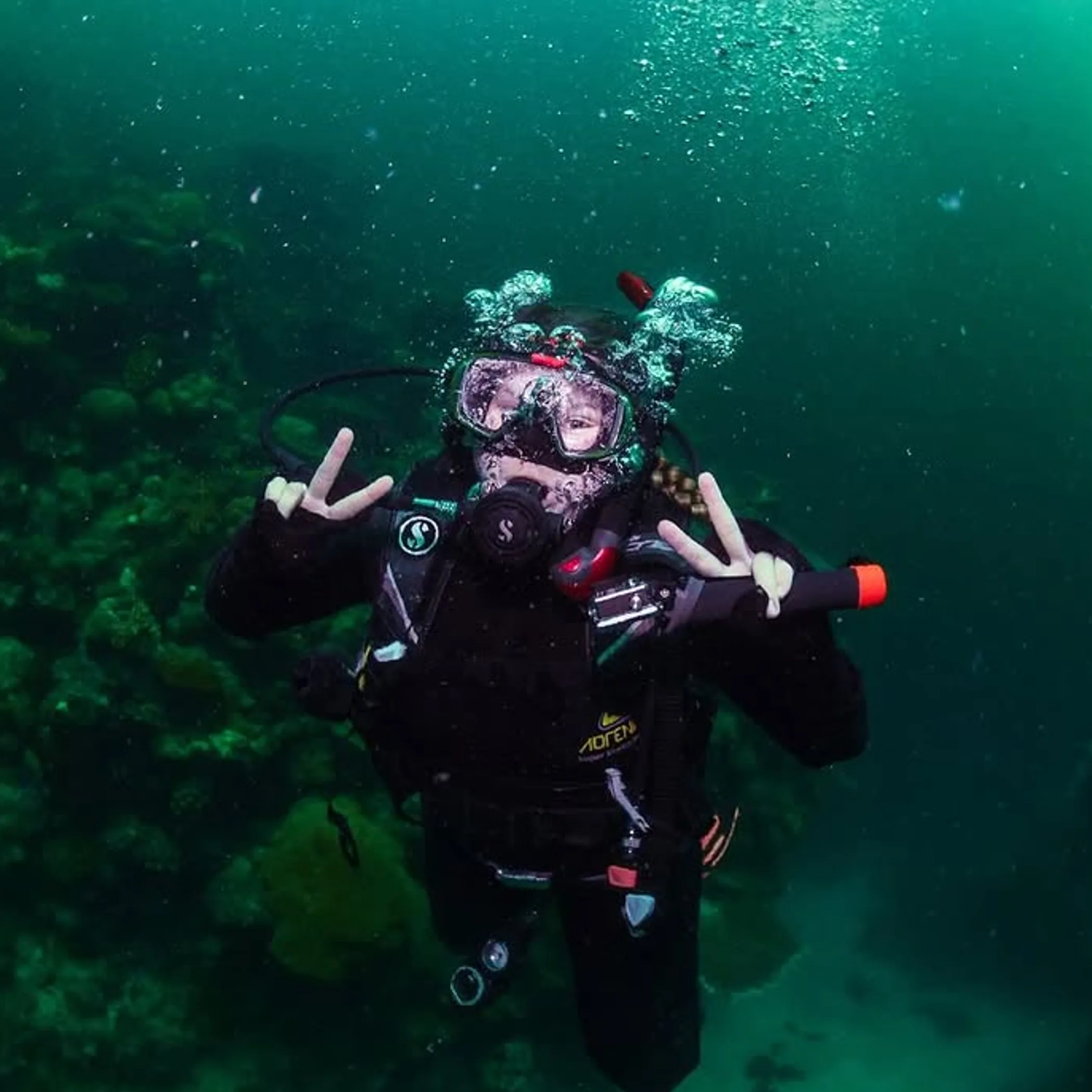 scuba diver exploring coral reef